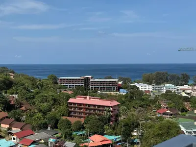 an overhead view of a city with buildings and the ocean at Luxury Seaview studio apartment at Karon beach in Karon Beach