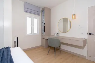 a bedroom with a vanity and a mirror and a chair at Patong private pool Villa 5BR 4Bath in Patong Beach