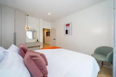 a bedroom with a white bed with pillows on it at Patong private pool Villa 5BR 4Bath in Patong Beach
