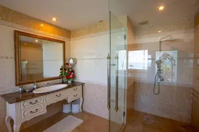 a bathroom with a sink and a glass shower at Two bedrooms Penthouse Seaview Rawai Beach Phuket in Phuket Town