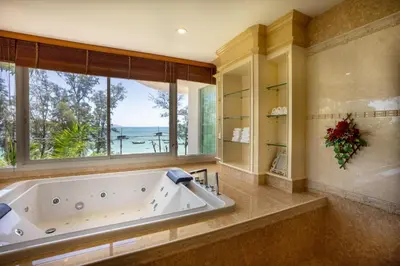 a large bathroom with a large tub and a window at Two bedrooms Penthouse Seaview Rawai Beach Phuket in Phuket Town