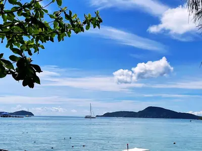 a view of the ocean with a boat in the water at Two bedrooms Penthouse Seaview Rawai Beach Phuket in Phuket Town