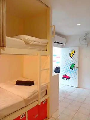 a room with two bunk beds and a wall with fish on it at Go To Party Hostel and Bar Aonang in Ao Nang Beach