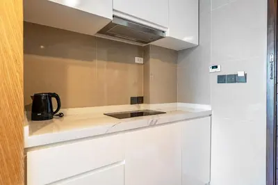 a kitchen with white cabinets and a black appliance at Super 2Bdr Apartament La Vita Rawai Naiharn beach in Rawai Beach