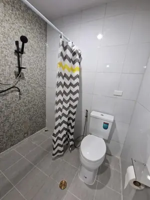 a bathroom with a toilet and a shower curtain at Bonanza Patong Beach2 100m to Beach Green Room in Patong Beach