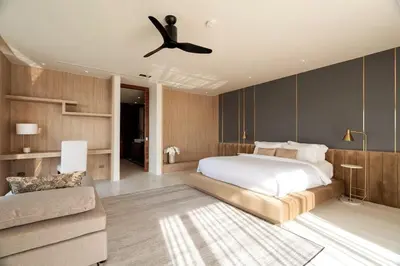 a bedroom with a bed and a ceiling fan at 33 - The Cove in Laem Singh Beach in Surin Beach
