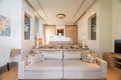 a living room with a couch and a bed at 33 - The Cove in Laem Singh Beach in Surin Beach