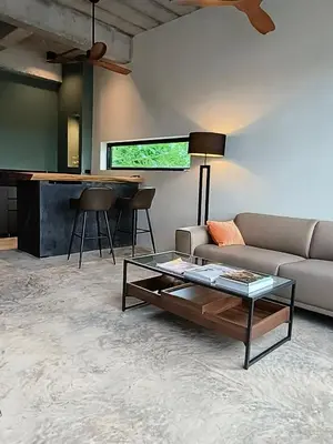 a living room with a couch and a table at Sky Lofts Airport Phuket in Nai Yang Beach