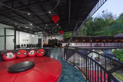 a red table with red pillows on a balcony at Chalong - 10 BR Private Pool Villa - Villa Nap Dau - Phuket in Chalong