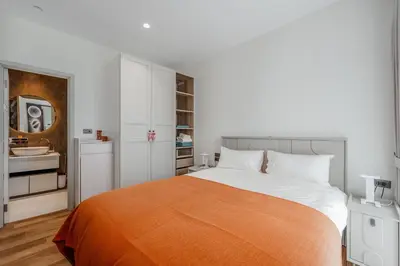 a bedroom with a bed with an orange blanket at Квартира в The Title Halo 1 in Nai Yang Beach