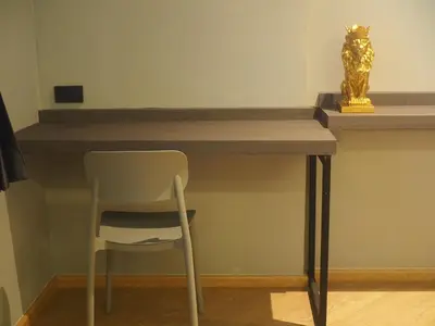 a desk with a chair and a gold cat statue at Leon's Loft House in Patong Beach