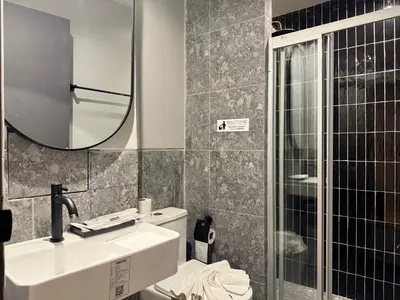 a bathroom with a sink and a mirror and a toilet at Leon's Loft House in Patong Beach