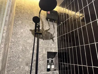 a shower with bottles of wine in a bathroom at Leon's Loft House in Patong Beach