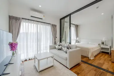 a white living room with a bed and a white couch at Квартира в The Title Halo 1 in Nai Yang Beach