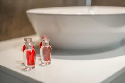 two small glass bottles sitting on top of a white sink at Квартира в The Title Halo 1 in Nai Yang Beach
