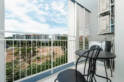 a room with a balcony with a table and chairs at Квартира в The Title Halo 1 in Nai Yang Beach