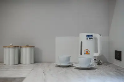 two cups sitting on a counter with two trash cans at Квартира в The Title Halo 1 in Nai Yang Beach