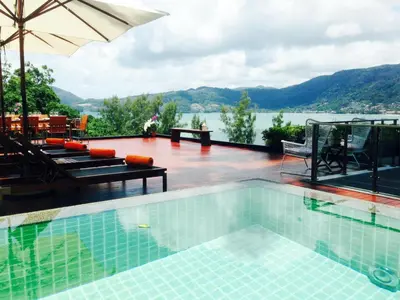 a swimming pool with a view of the water at Jirana Patong in Patong Beach