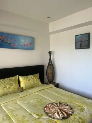 a bedroom with a bed with a bowl on it at Family place in Ban Saiyuan (1)