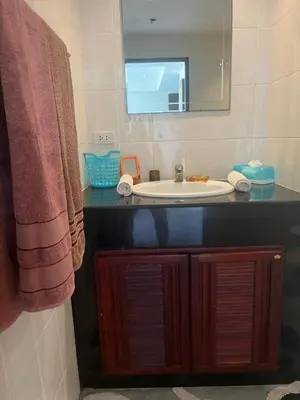 a bathroom with a sink and a mirror at Family place in Ban Saiyuan (1)