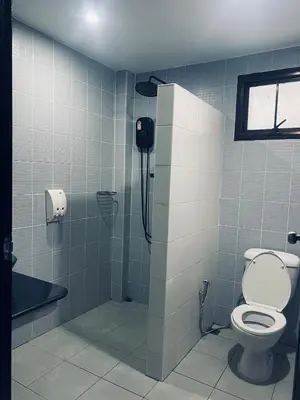 a bathroom with a toilet and a phone on the wall at Гостевой домик in Ban Saiyuan (1)