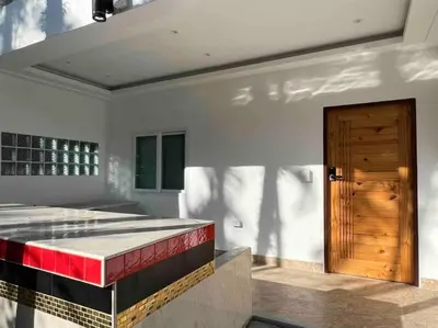 a room with a bed and a wooden door at Charming Villa Suite with Cozy Terrace near Beach in Patong Beach