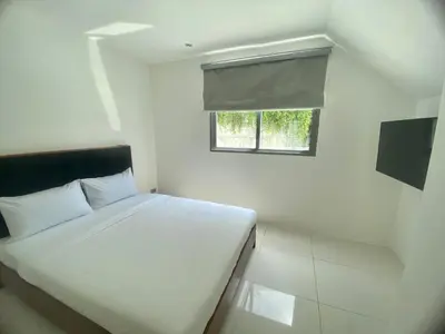 a white bedroom with a bed and a window at The View Condominium 360 m2 Sea View Penthouse in Kata Beach