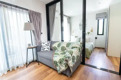 a living room with a couch and a bed at Paradise Bird in Nai Yang Beach