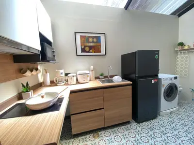 a kitchen with a sink and a washing machine at Sea Breeze Villa Patong in Patong Beach