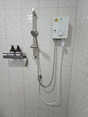a shower with a shower head in a bathroom at Aonang Riverside Home in Ban Khlong Son