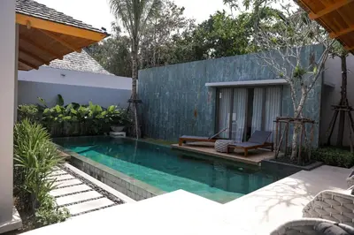 a swimming pool in the backyard of a house at Bang Tao Anchan Flora 3 bd in Ban Phru Champa