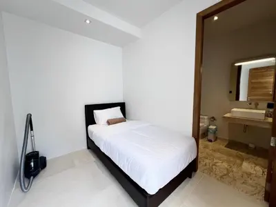 a bedroom with a white bed and a mirror at Bang Tao Anchan Flora 3 bd in Ban Phru Champa