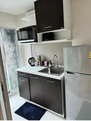 a small kitchen with a sink and a refrigerator at Lux Center Apartment in Kathu