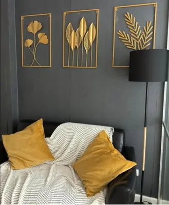 a bedroom with a bed with yellow pillows and pictures on the wall at Lux Center Apartment in Kathu