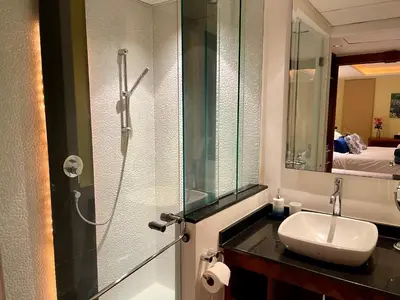 a bathroom with a sink and a shower at Kata Seaview Serenity - Luxury 1BR Apartment in Karon Beach