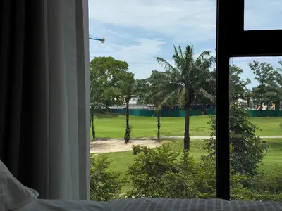 a view from a bedroom window of a golf course at Skypark by Villacarte in Laguna Phuket