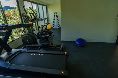 a room with a gym with a treadmill at New 1BDR Fantasea Kamala beach in Kamala Beach