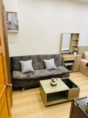 a living room with a couch and a coffee table at Baannira บ้านนิรา in Ban Sam Kong