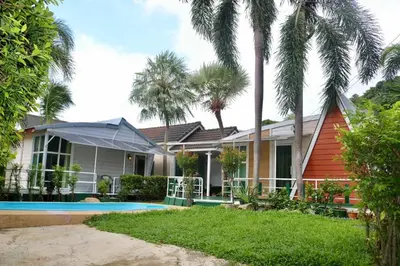 a house with a swimming pool and palm trees at 2 Bedrooms House with Private Pool the heart of rawai in Ban Saiyuan (1)
