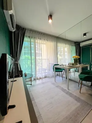 a living room with a table and a dining room at Central Pool in Ban Lo Long