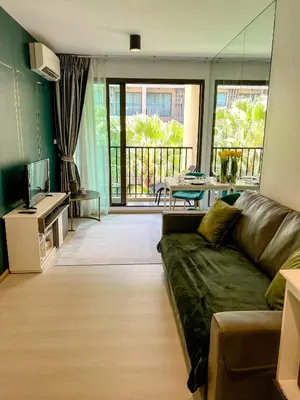 a living room with a couch and a balcony at Central Pool in Ban Lo Long