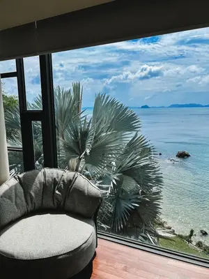 a couch sitting in front of a window looking out at the ocean at Rare Sunrise Cliff Villa 5 Bedrooms in Ban Lo Ti Pa (1)