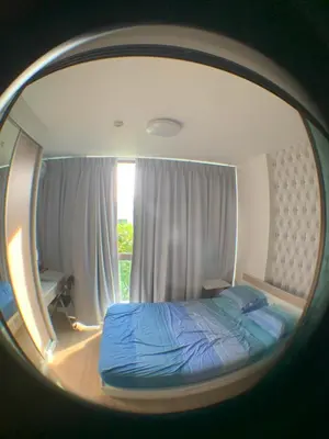 a reflection of a bed in a round mirror at Fab condo in Ban Tha Khreng