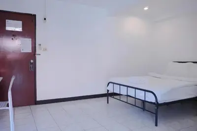 a hospital room with a bed and a chair at XX GO INN Patong Beach in Patong Beach