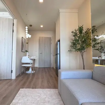a living room with a couch and a table at DLUX 7TH Floor in Ban Klang