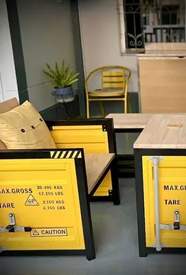 two tables and chairs with signs on them at Casa Gris with Shared Pool in Ban Bo Han