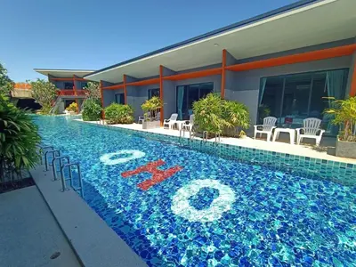 a swimming pool in front of a house at Ohophuket in Phuket Town