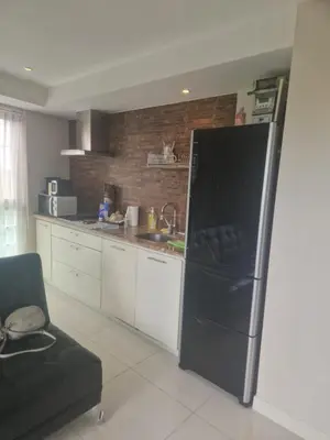 a kitchen with a black refrigerator in a kitchen at Condo for rent Kata Beach in Kata Beach