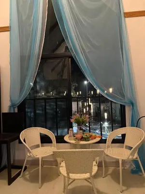 a table and chairs in a room with a window at Cat Home Ao Nang Landmark in Ao Nang Beach