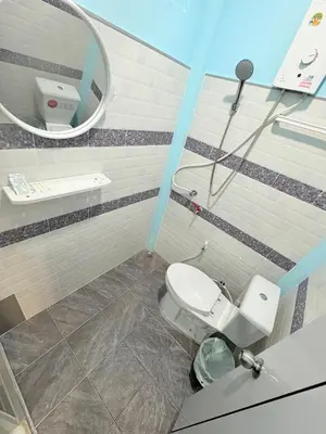a bathroom with a toilet and a mirror at Abir Homestay Koh Yao Yai in Ban Phlu Nai